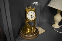 A 400 day anniversary clock having glass dome and German made movement