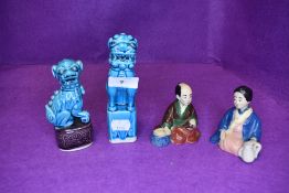 Two blue glazed Chinese temple dogs of Fo and a near pair of Japanese nodding head figures