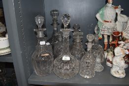 A selection of early to late Victorian spirit bottles and decanters including cut and moulded glass
