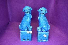 A pair of Chinese export temple dogs of Fo having blue glaze both 25cm tall approx