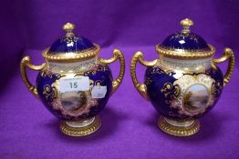 A pair of Coalport twin handle urns or trophy having cobalt blue glaze and gilt detailing with