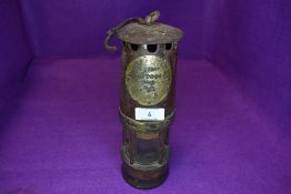 A genuine miners lamp having steel and brass case by Hailwood and Ackroyd model and number worn