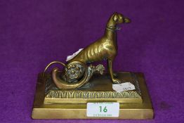 A Victorian desk top figure of a Grey Hound or similar racing dog brass cast
