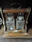 A decanter set of two bottles with oak case having brass fitments