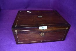 A late Victorian sewing case with rose wood body inlayed with brass and mother of pearl some