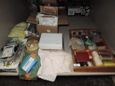 An assortment of vintage haberdashery including buttons,buckles,thread and more.