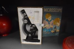 A vintage childs scientific microscope in case no. 207-Z