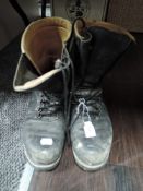 A pair of high top black work or walking boots.