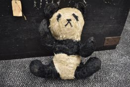 A mid 20th century straw filled Panda Bear having stitched nose and mouth, stitched boy with movable