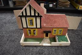 A hand made wooden Dolls House having two downstairs rooms and one bedroom along with hand made