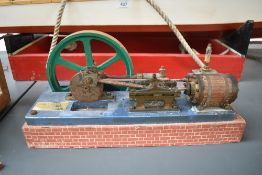 A Single Cylinder horizontal live steam model Mill Engine having spoked flywheel on wood base,