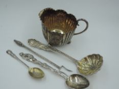 A small Victorian silver cream jug having engraved floral and scallop shell decorative panels