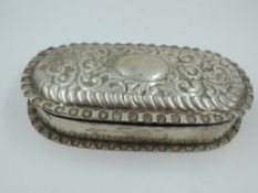 A Victorian silver trinket box of oval form having crimped rims and moulded decoration to hinged