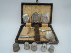 A small selection of HM silver including three vestas, a cased baby's first cutlery set, and five HM