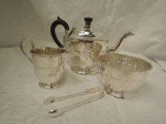 A silver three piece tea service of circular form having facetted decoration, decorative rims,