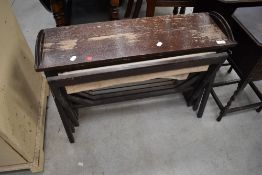 A vintage stained frame pull out canvas guest bed