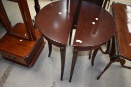 A pair of reproduction mahogany effect demi lune hall tables