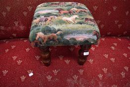 A vintage footstool with equine horse related upholstery