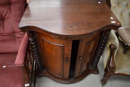 A 19th Century mahogany drinks or similar cabinet having sliding bow front doors, possibly later
