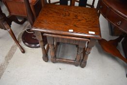 An oak Priory style nest of two tables
