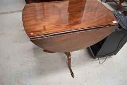 An interesting 19th Century and later pedestal table having turned column base on triple splay