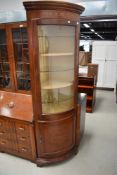 A reproduction hardwood corner display having mock inlay decoration , glazed upper section and lower