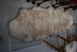 A vintage style sheepskin rug, approx 186 x 65cm