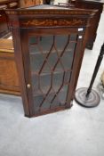 An Edwardian mahogany and inlaid corner wall display cabinet having astral glazed door