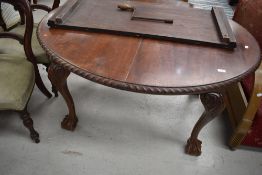 A late 19th or early 20th Century mahogany wind out dining table having oval top with gadrooned edge