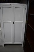 A vintage painted wardrobe and similar four drawer chest