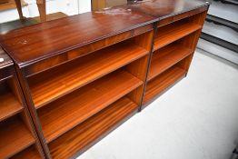 A pair of reproduction mahogany bookshelves, labelled Shaw of London