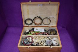 A Fortnum & Mason bottle box containing a selection of modern costume jewellery
