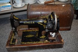 A crank handled Singer sewing machine, serial number F8690956.