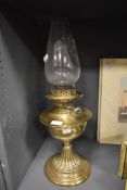 A Victorian oil burning lamp having decorative base by Youngs De Lite