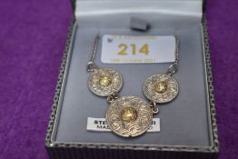 An Irish silver necklace of Celtic form having yellow metal decoration and fixed chain, a three