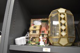 A cut glass light shade having bevel edged glass and a model house by Caddington