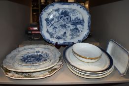 A selection of vintage and antique platters including blue and white ware.