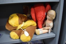 A selection of soft toys including red elephant teddy bear and doll
