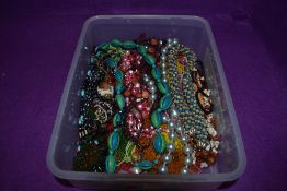 A box of costume jewellery necklaces, mainly of multi strand bead form