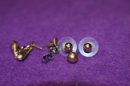 Two pairs of 9ct gold stud earrings and two odd gold earrings, approx 1g