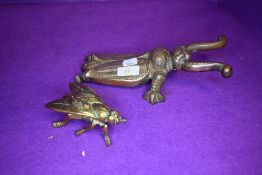 A vintage cast iron boot pull in the form of a beetle and a similar brass wasp box