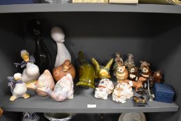 A selection of figures and figurines including ducks and cats also a mid century green glazed