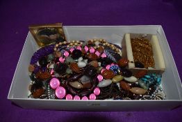 A box of costume jewellery necklaces of various forms and a powder compact