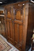 An early 20th Century oak priory style wardrobe