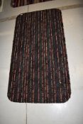 A carpet remnant rug, having rounded edges, approx. 130 x 68cm