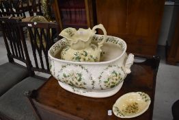 A reproduction footbath, wash jug and soap dish