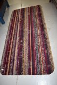 A carpet remnant rug, having rounded edges, approx. 190 x 92cm