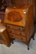 A mid 20th Century walnut dwarf bureau on cabriole legs