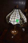 A Tiffany style desk or table lamp having Art Nouveau style base