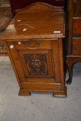 A Victorian golden oak coal purdonium having carved mask decoration to front panel